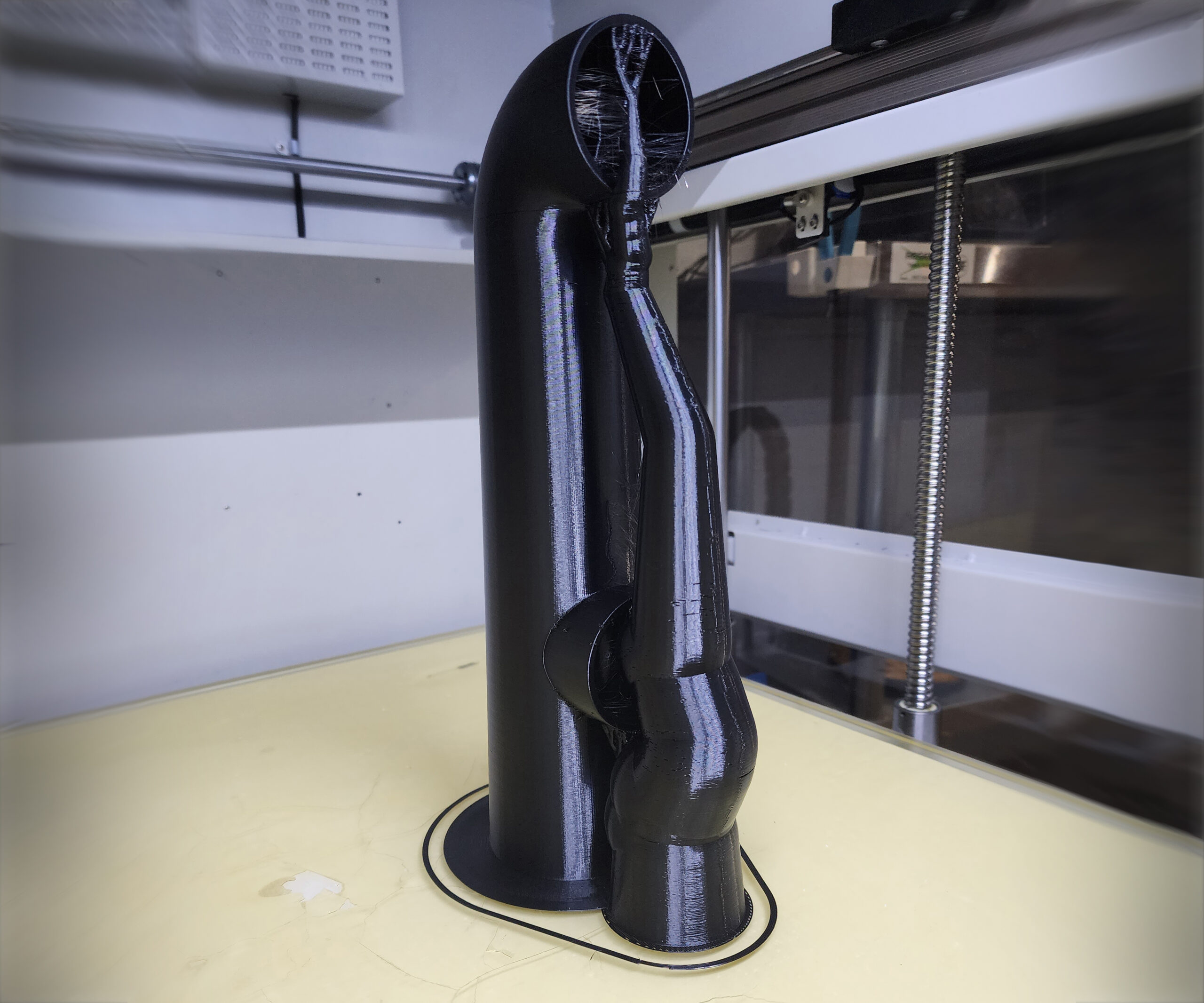 3D-printed abstract black sculpture on table.