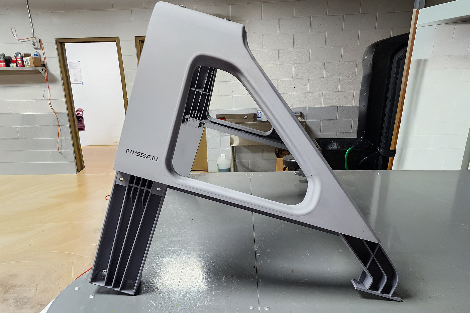 Nissan car part on a workshop table. Nissan car part on a workshop table.