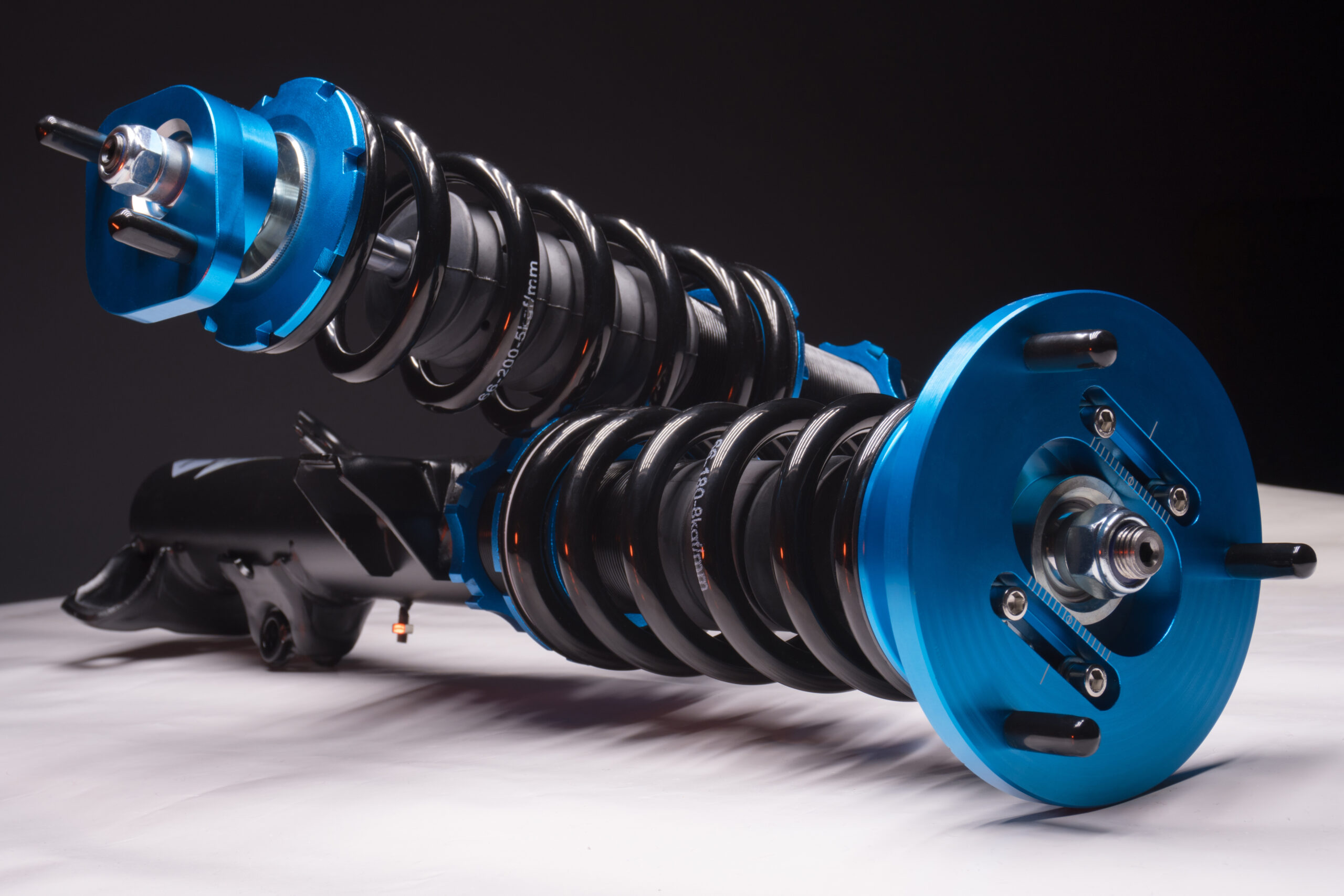 Blue and black car suspension coilovers. Blue and black car suspension coilovers.